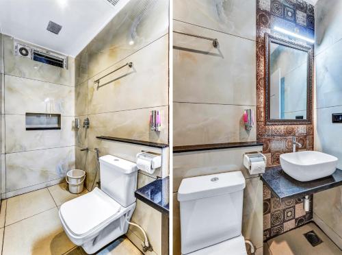 a bathroom with a toilet and a sink at IZI Beach Stay Mahabalipuram in Chennai