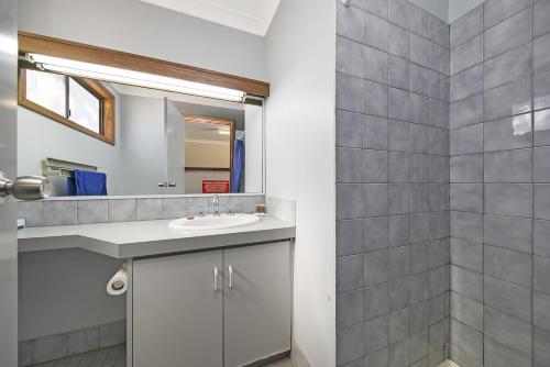 a bathroom with a sink and a mirror at Border Village Roadhouse in Border Village
