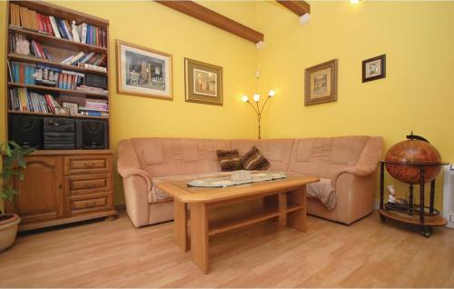a living room with a couch and a coffee table at Picturesque Escape Holiday Home with Pool and Sauna in Kastel Novi