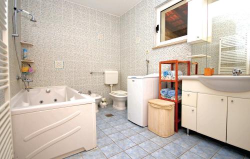 a bathroom with a tub and a toilet and a sink at Picturesque Escape Holiday Home with Pool and Sauna in Kastel Novi