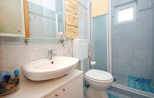 a bathroom with a white sink and a toilet at Picturesque Escape Holiday Home with Pool and Sauna in Kastel Novi