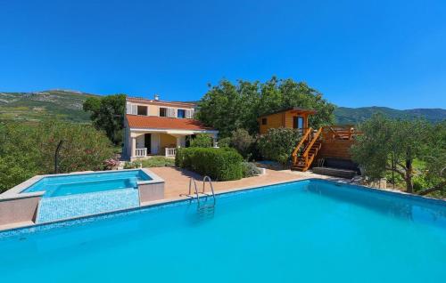 a villa with a swimming pool and a house at Picturesque Escape Holiday Home with Pool and Sauna in Kastel Novi