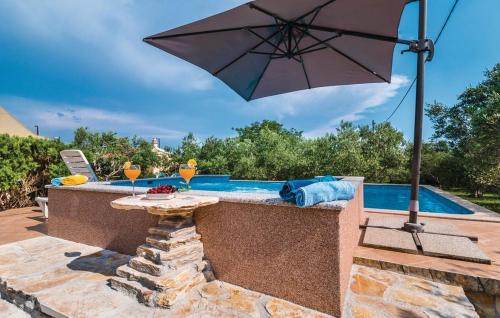 a patio with an umbrella next to a swimming pool at Picturesque Escape Holiday Home with Pool and Sauna in Kastel Novi