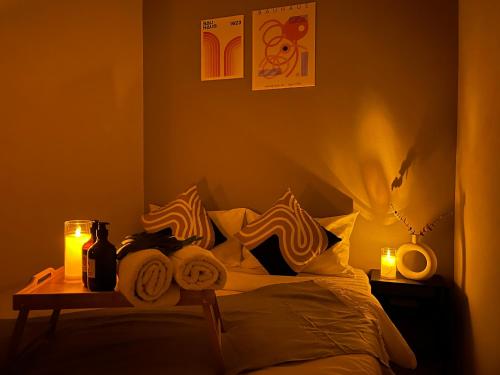 a bedroom with a bed with pillows and a table at Stylish&Affordable Serenity Suite #2min KekLokSi in Ayer Itam