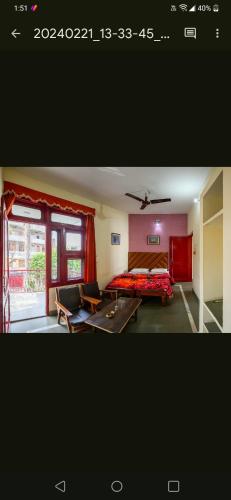a picture of a bedroom with a bed and a window at Falcon guest house in Bharatpur