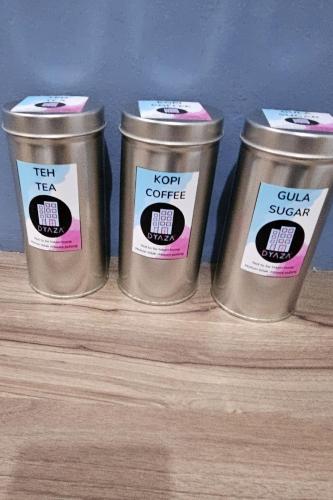 four metal containers sitting on a shelf with labels on them at DYAZA LV Pekanbaru Near Sultan Syarif Kasim Airport and UIR in Pekanbaru