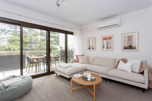 a living room with a couch and a table at Breaksea Villa Walk to The Beach in South Beach