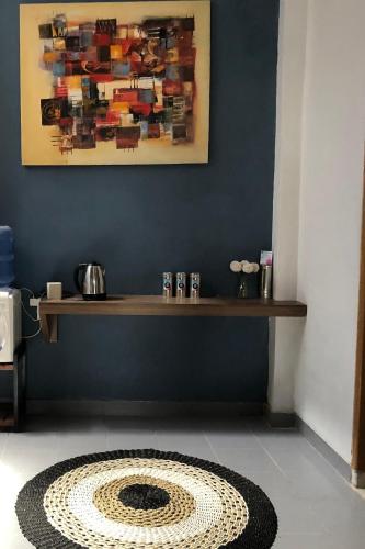 a room with a table with a painting on the wall at DYAZA LV Pekanbaru Near Sultan Syarif Kasim Airport and UIR in Pekanbaru