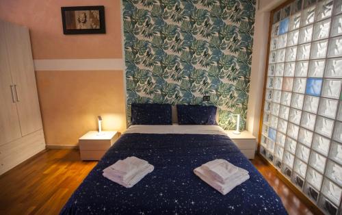 a bedroom with a bed with two towels on it at Casa Carina in Verona