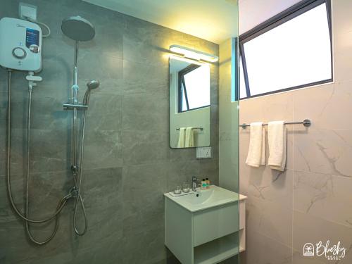 a bathroom with a shower and a sink at Blue Sky Beach in Hulhumale