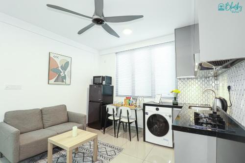 a kitchen and a living room with a ceiling fan at Blue Sky Beach in Hulhumale
