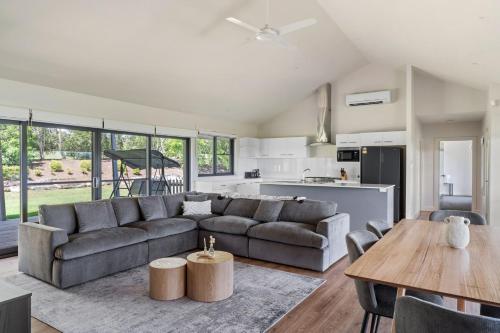 a living room with a couch and a table at Travertine Vineyard Retreat - Stay Among the Vines in Pokolbin