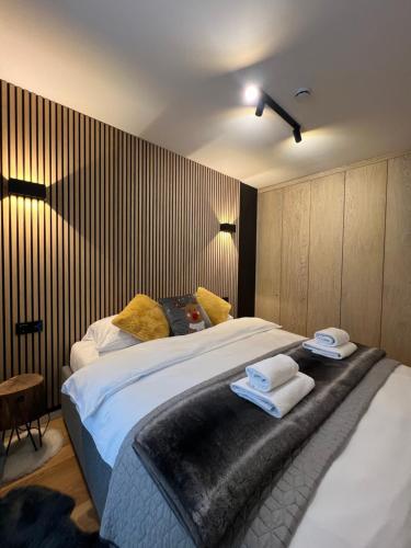 a bedroom with a large bed with towels on it at Magi - Apartment with balcony in Jahorina