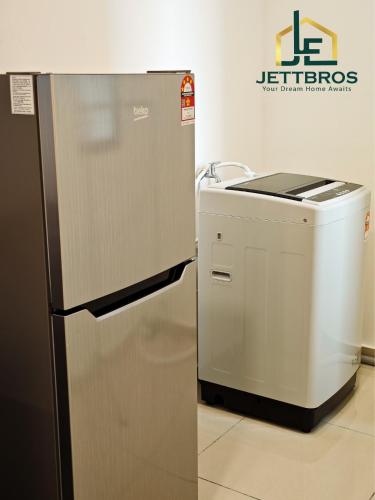 a kitchen with a refrigerator and a washing machine at D' Summit Residence By JettBros Johor Bahru in Johor Bahru