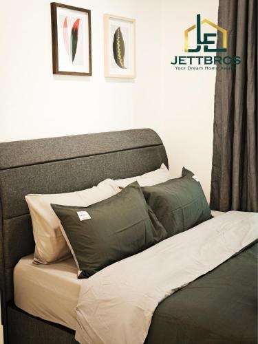 a bed with pillows on it in a room at D' Summit Residence By JettBros Johor Bahru in Johor Bahru