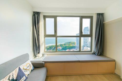 a bed in a room with a large window at The Sóng Vũng Tàu- SAO VIỆT Căn Hộ Nghỉ Dưỡng 5 Sao in Vung Tau