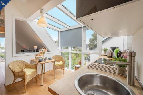 a kitchen with a sink and a large window at Ferienhaus am Peenestrom in Quilitz