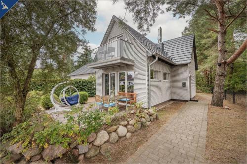 a small house with a patio in front of it at Ferienhaus am Peenestrom in Quilitz