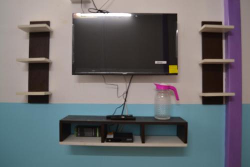 a flat screen tv sitting on top of a shelf at SS Tiny Home Stays in Kolli Hills