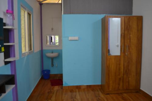 a room with a door and a sink at SS Tiny Home Stays in Kolli Hills