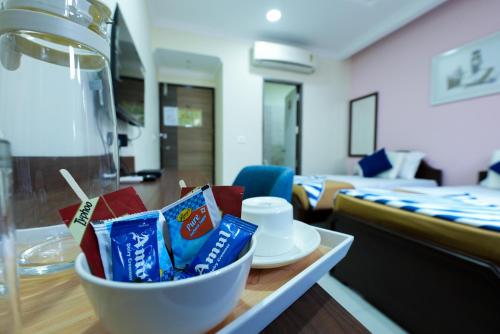 a bowl of chips on a table in a living room at Madras Inn - Alwarpet in Chennai