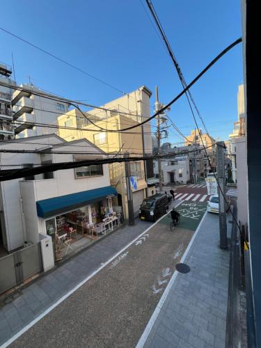 a person riding a bike down a city street at 全新装修南品川haven春 in Tokyo