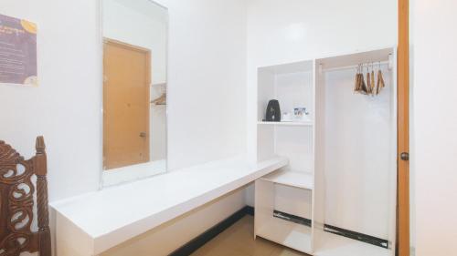 a room with white walls and a white shelf at RedDoorz @ Lualhati Garden Cottage El Nido Palawan in El Nido