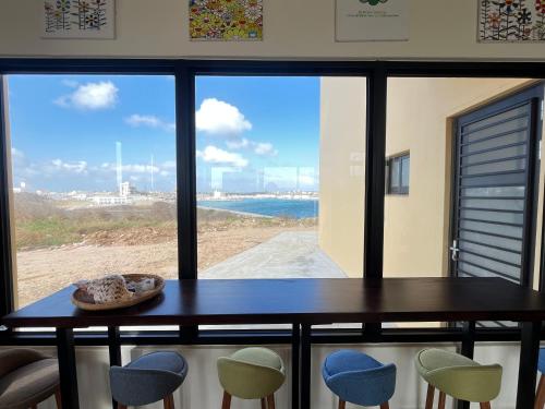 a table and chairs with a view of the ocean at Shuye Mumu BnB in Magong