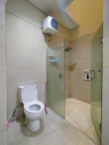 a bathroom with a toilet and a shower at Cheery Home Surabaya 10 mins toll near Pakuwon Mall in Surabaya