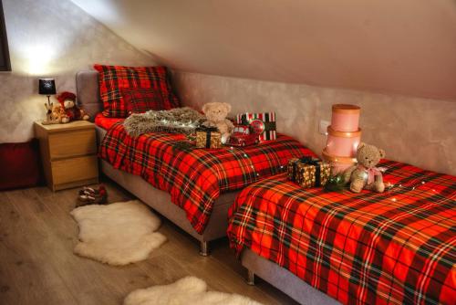a bedroom with two beds with teddy bears on them at Apartmany pod Pustevnami in Prostřední Bečva
