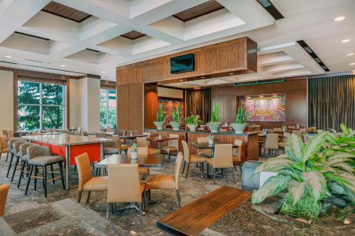 a restaurant with tables and chairs in a room at Embassy Suites Houston - Downtown in Houston