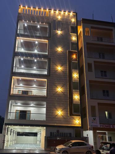 a building with lights on the side of it at Nest Inn Homestay in Tirupati