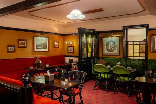 a restaurant with tables and chairs and a red couch at Hilton Cairo Heliopolis Hotel in Cairo
