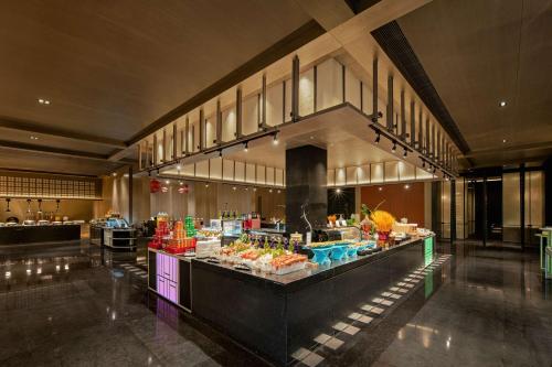 a buffet line in a building with food on display at Doubletree By Hilton Kaifeng in Kaifeng