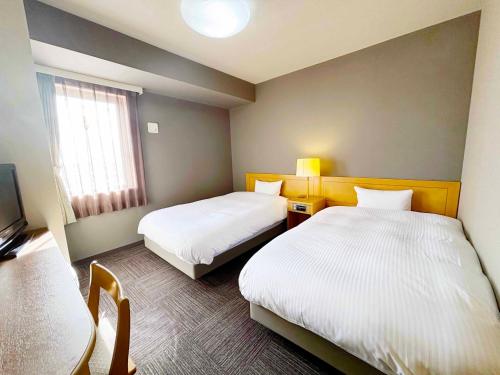 Postel nebo postele na pokoji v ubytování Route Inn Grantia Hanyu Spa Resort
