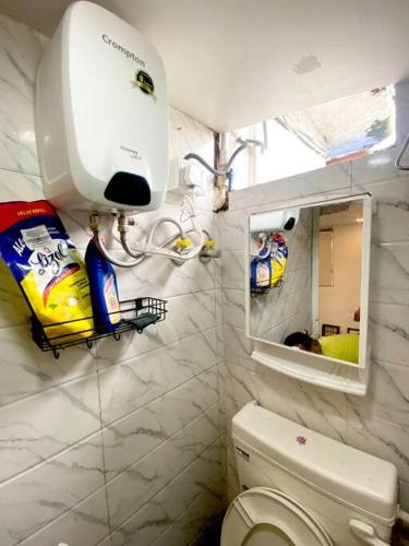 a small bathroom with a toilet and a mirror at Budget friendly Mini Heaven 2 in Kolkata