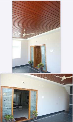 two views of a room with a ceiling and a door at Nest Inn Homestay in Tirupati
