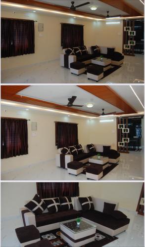 a living room with a couch and a table at Nest Inn Homestay in Tirupati