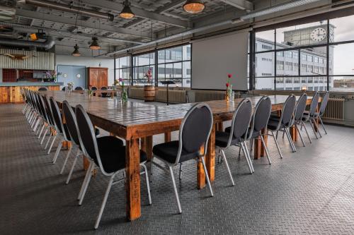 a large conference room with a long table and chairs at Stayokay Hostel Eindhoven in Eindhoven