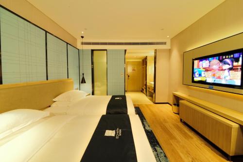 TV a/nebo společenská místnost v ubytování Echarm Hotel Yulin Second People's Hospital Qingwanjiang Park