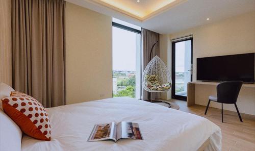 a hotel room with a bed with a book on it at 熙之光屋 in Dongshan