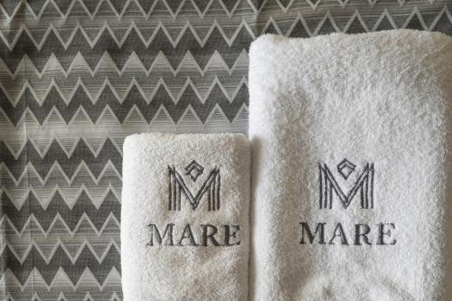 two towels sitting next to each other on a table at Mare Village Hotel in Georgioupolis