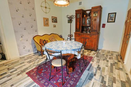 a dining room with a table and chairs in a room at Leon Rooms in Tbilisi City