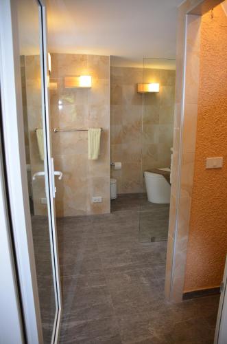 a bathroom with a glass shower and a toilet at Villa Leo - Koh Chang in Trat