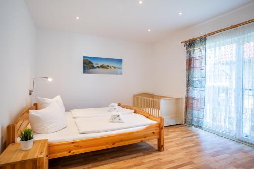 a bedroom with a bed and a large window at Ferienhaus Waldheide in Zempin