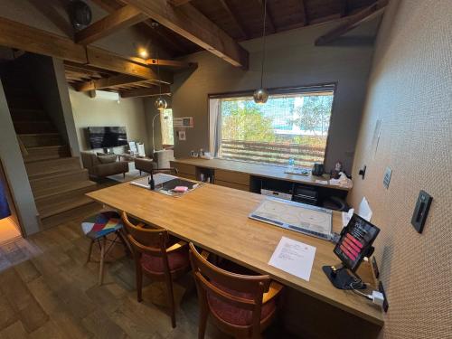 a kitchen with a large wooden table and chairs at ルネ熱海伊豆山villa134 in Atami