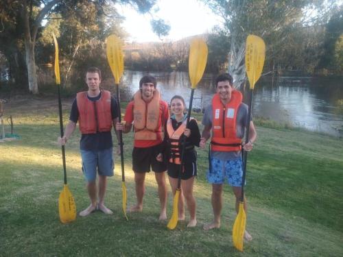 a group of four people wearing life jackets and holding paddles at Merwespont Guesthouses#DieHouthuis#Die Wyntenke#A Snoozer's Cottage# in Bonnievale