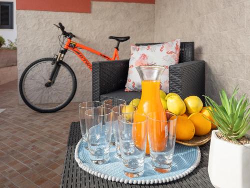 a tray of glasses on a table with a bike at Villetta a San Foca in San Foca