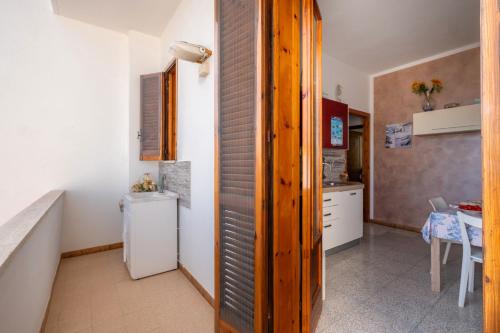 a kitchen with a sink and a toilet in a room at Villetta a San Foca in San Foca