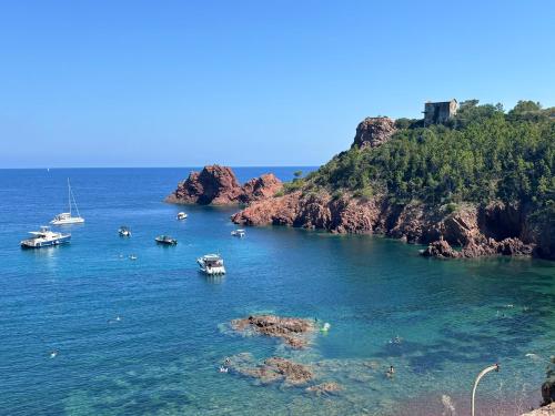 a group of boats in a body of water at Camping Vallée du Paradis in Agay - Saint Raphael